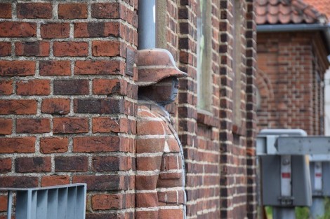 Man blending in with brick wall