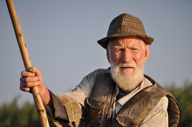 Old man fishing with concerned look on his face