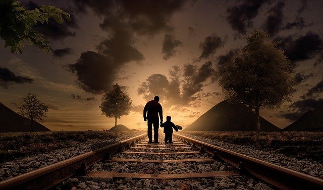 Father and son walking together holding hands