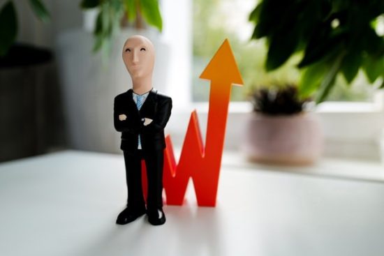 Small business man figure with an investing line behind him