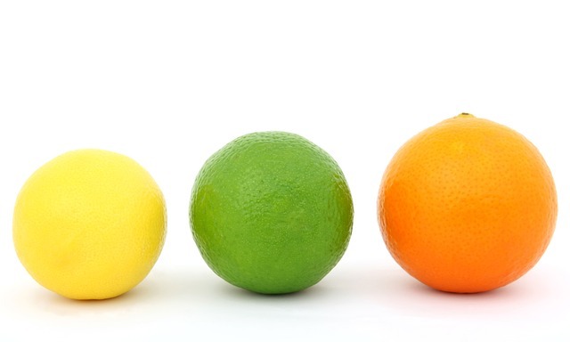 Picture of a lemon, lime, and an orange sitting next to eachother